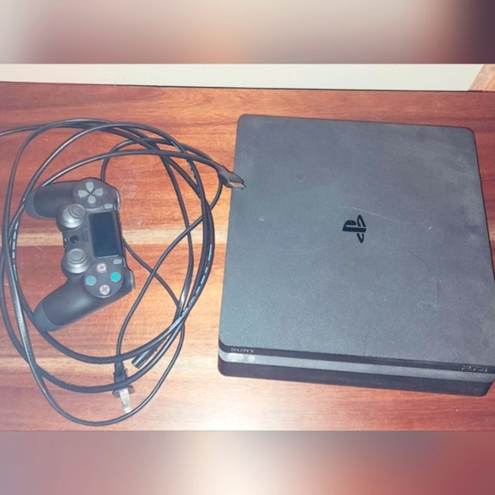Ps4 console with its original cords and hdmi wire. A remote controller.